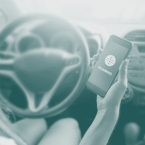 Woman in car holding mobile phone